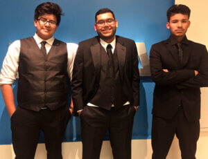 three Latino youths in suits
