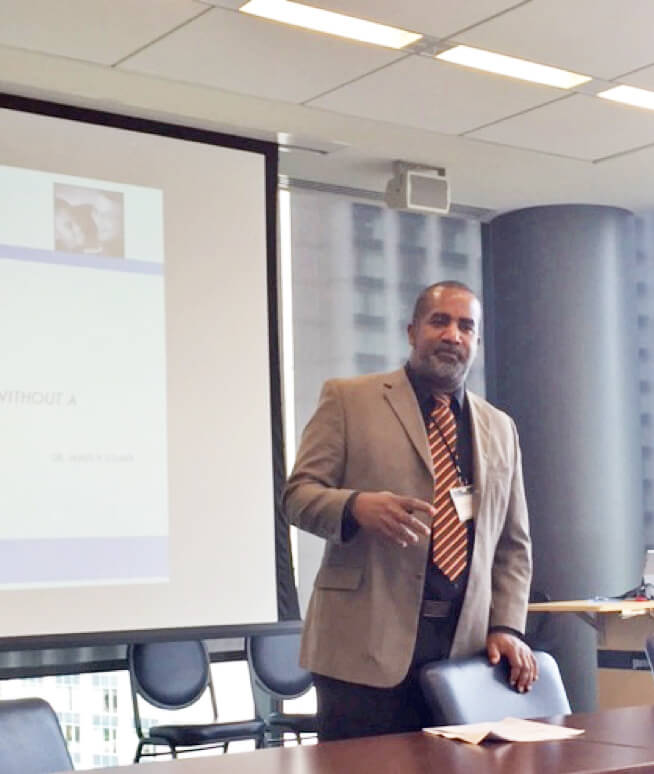 Person standing and presenting a powerpoint